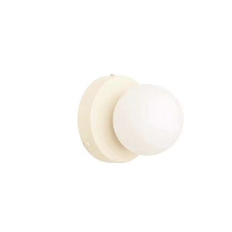White circular wall plate and white glass globe
