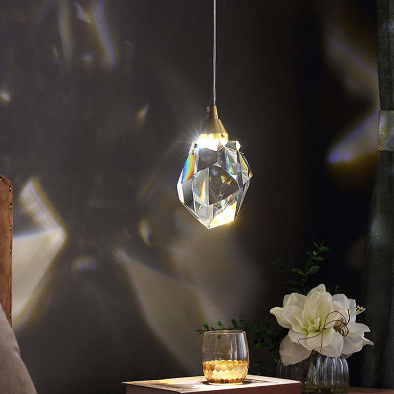 Kristy 1 Head crystal pendant illuminated above a dark tabletop