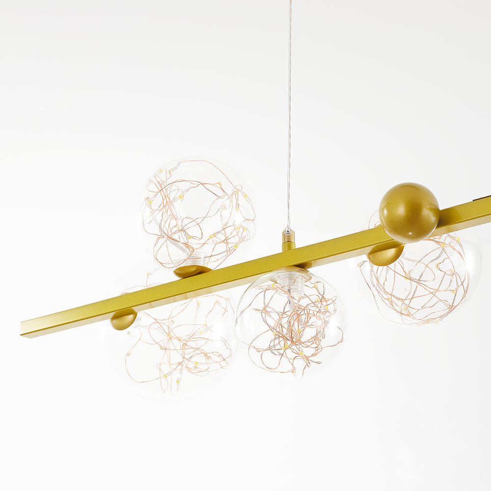 Close view of gold bar and clear globes filled with LED wire