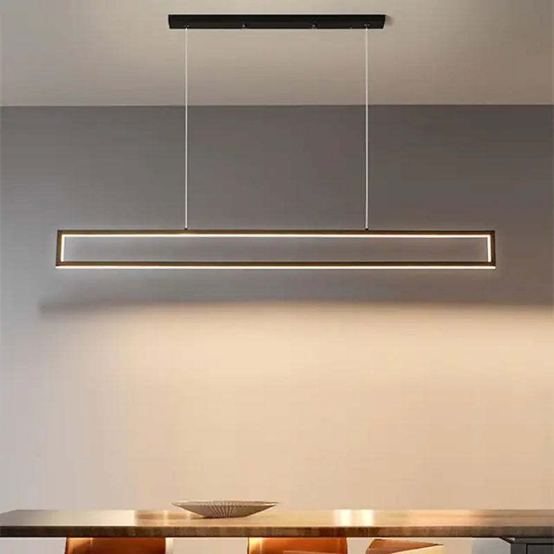 Edge rectangular pendant above a dining counter with a warm glow