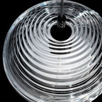 Top-angle detail of concentric Hailie glass ribs around a black cord entry