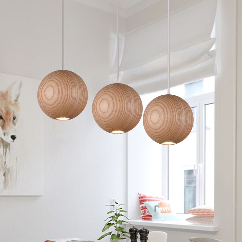 Three wood-grain globe lights near a window