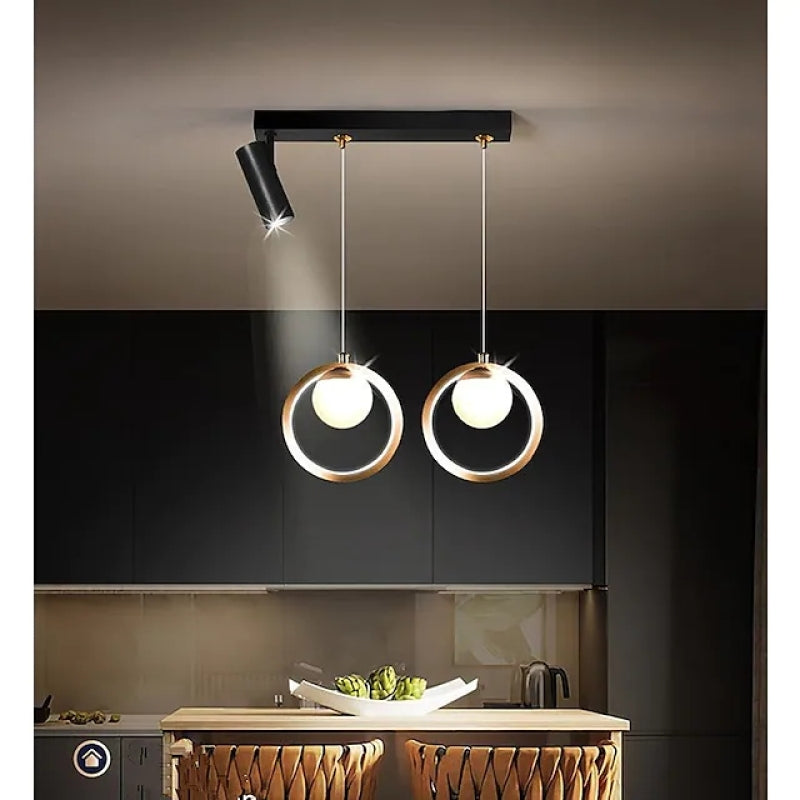 Madina two-ring pendant with white globes and two black spotlights above a kitchen.