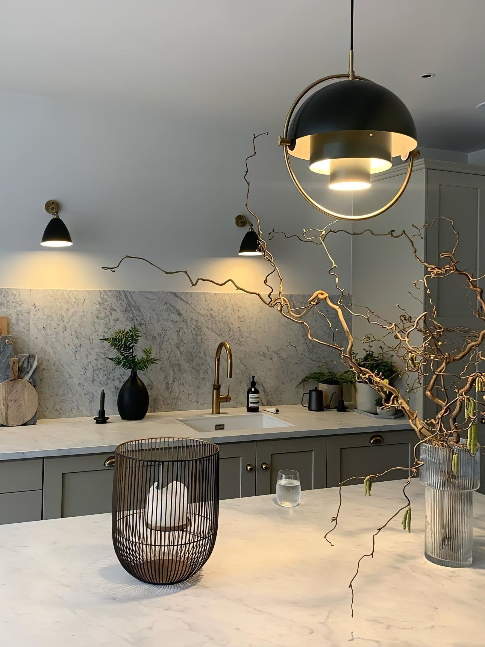 Illuminated black and copper-coloured pendant above a kitchen island