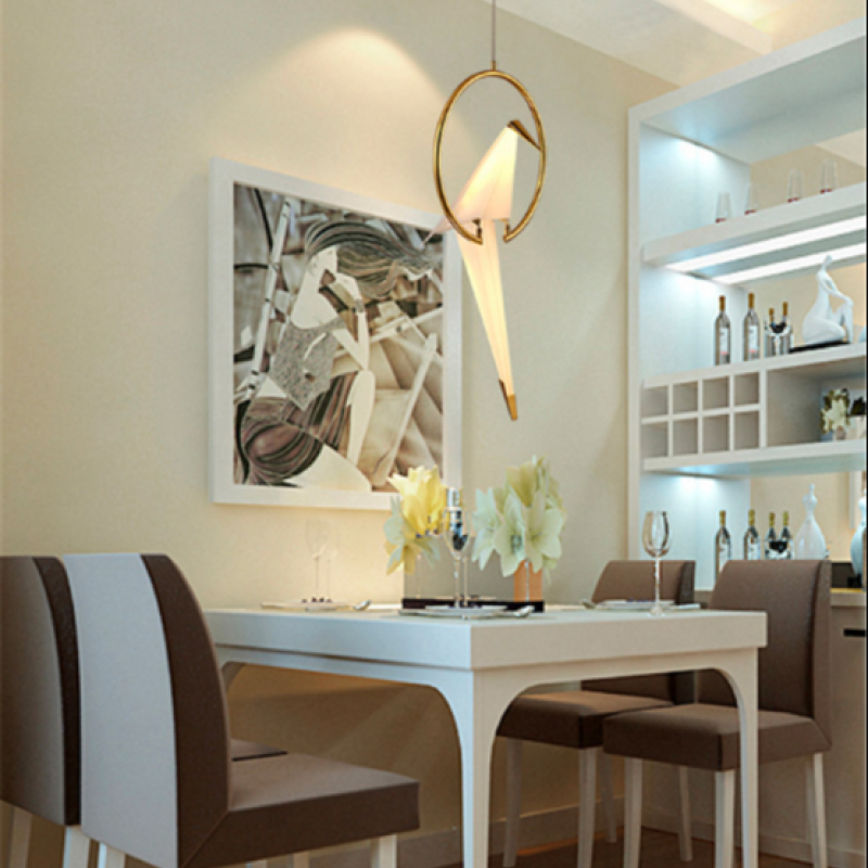Single-bird pendant above a dining area beside shelving.