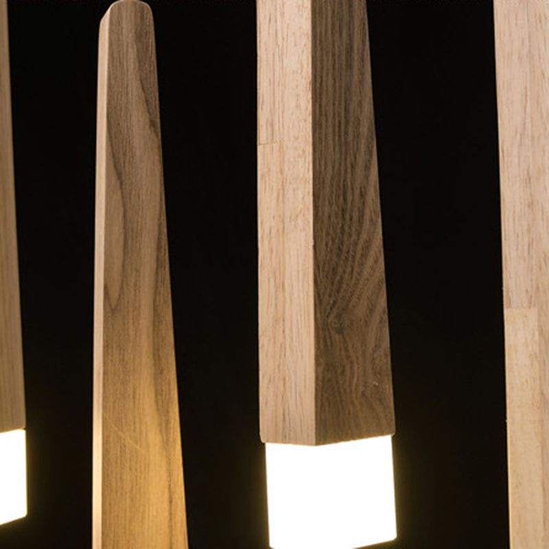 Close-up of illuminated white tips and long wood-grain faces on Ozawa column pendants.