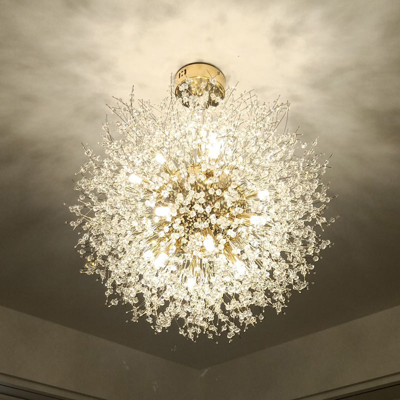Upward close view of lit gold Lili branches and clear faceted clusters beneath round ceiling canopy