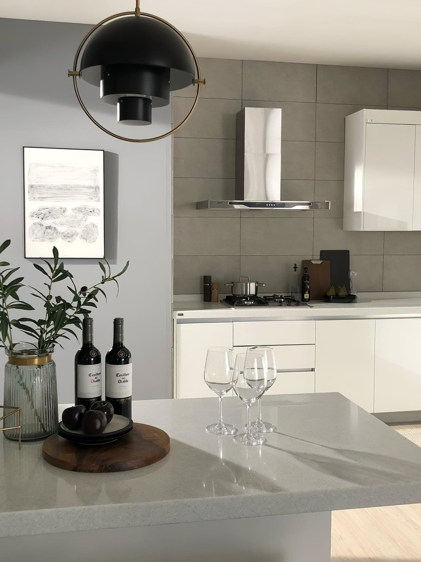 Black ring-framed pendant above a pale kitchen counter