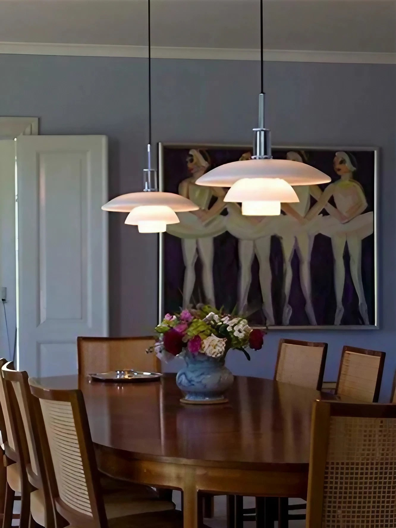 A group of opal disc pendants above a dining table
