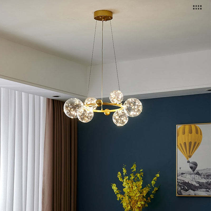 Small gold ring chandelier in room with vase