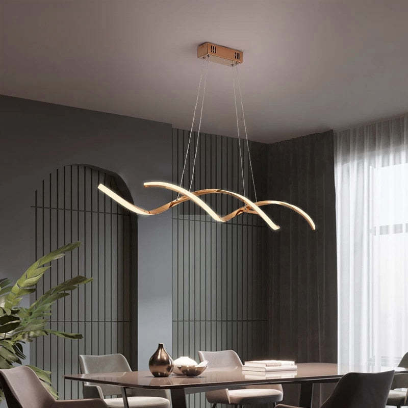 Gold Louise pendant above a dining table beside floor-length curtains
