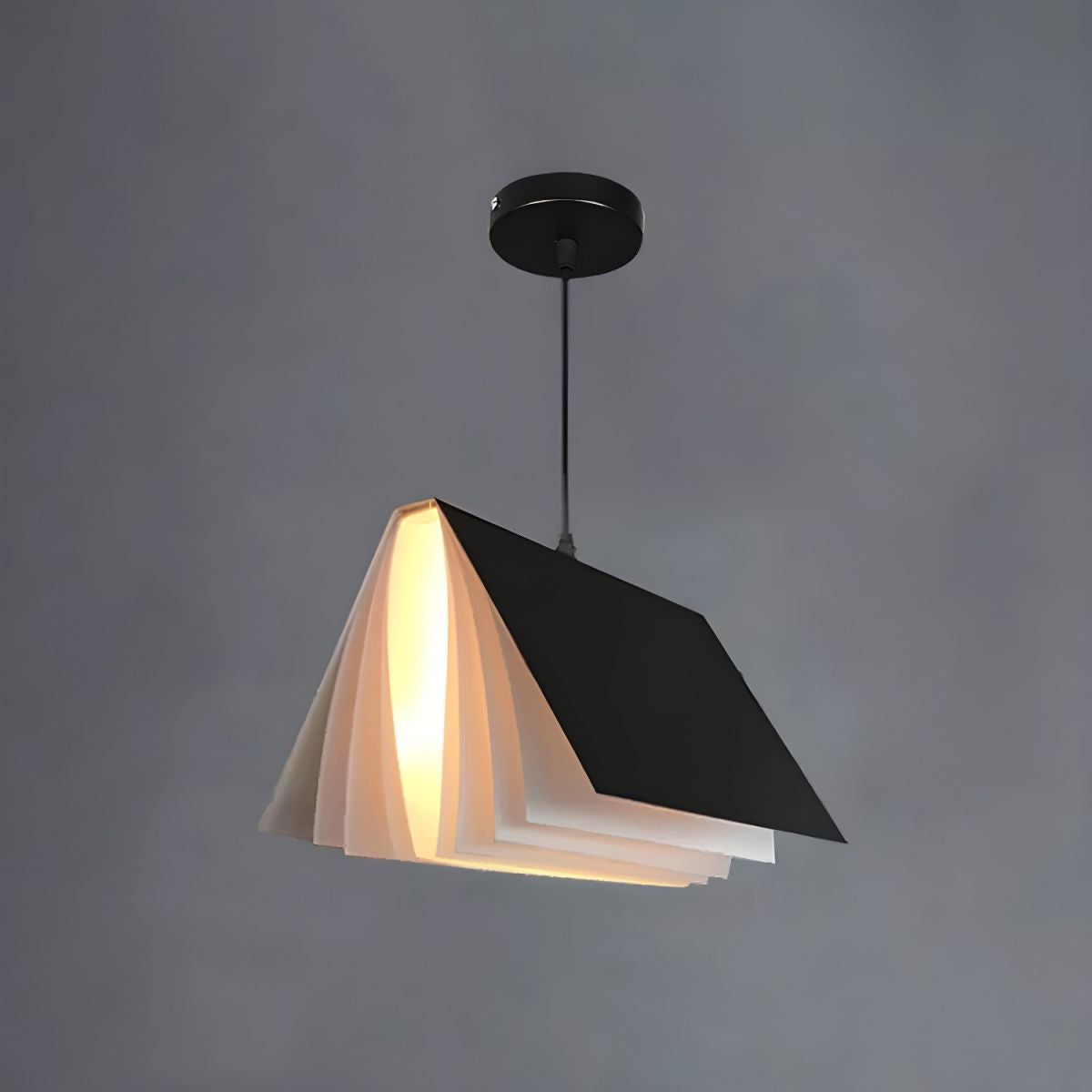 Black book-shaped pendant against grey background