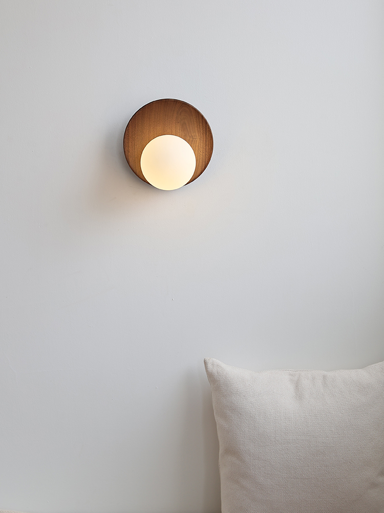 Front view of the Lunetta disc-and-globe wall lamp
