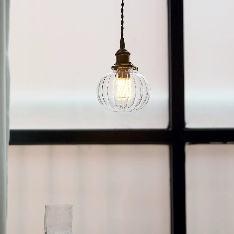 Hailie Style D ribbed globe pendant beside a window