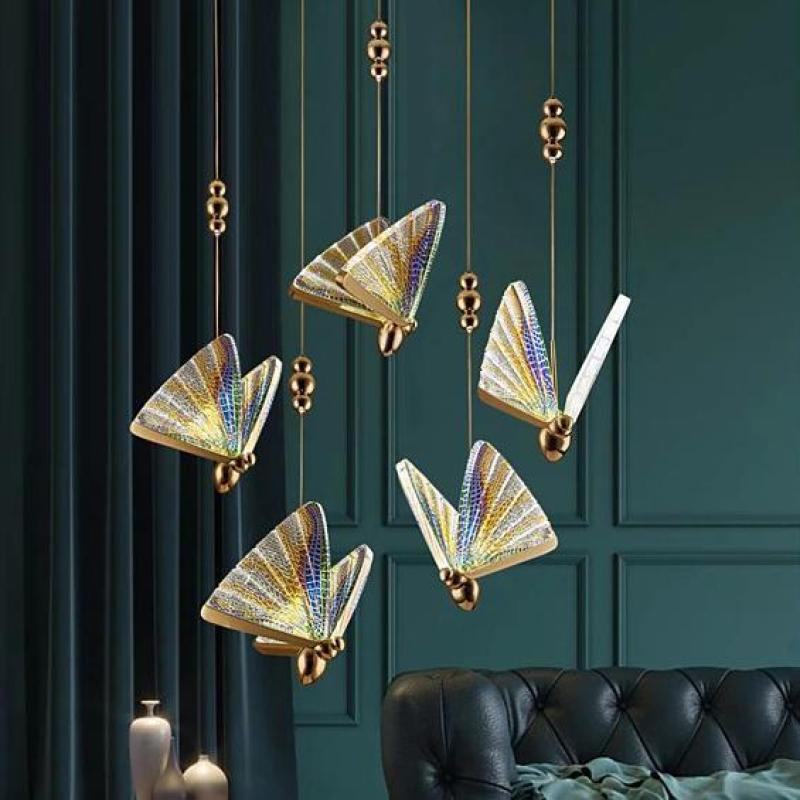 Colourful Kady butterfly pendants above seating beside a green wall