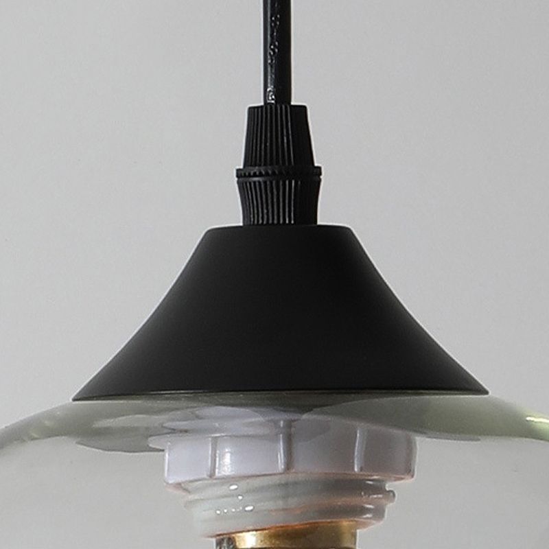 Close view of black conical fitting and clear glass lip