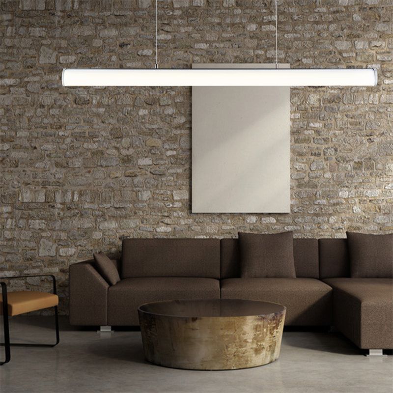 White tube pendant above a sofa and round coffee table