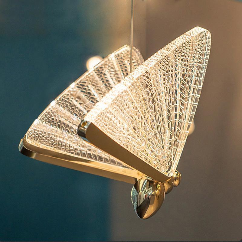 Close-up of the gold frame and textured wings on a Kady butterfly pendant