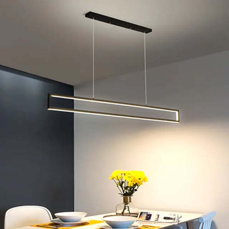 Edge slim rectangular pendant above a table with yellow flowers
