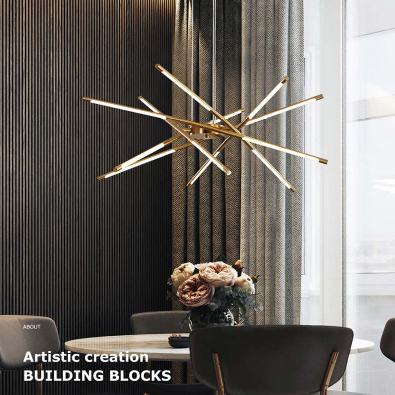 Gold crossed LED rods above round dining table with roses, textured curtain and bright window, with decorative caption