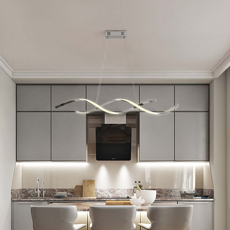 Chrome Louise pendant above a kitchen island with two stools