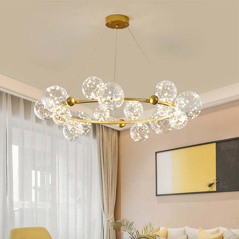 Gold circular glass-globe chandelier in bright interior