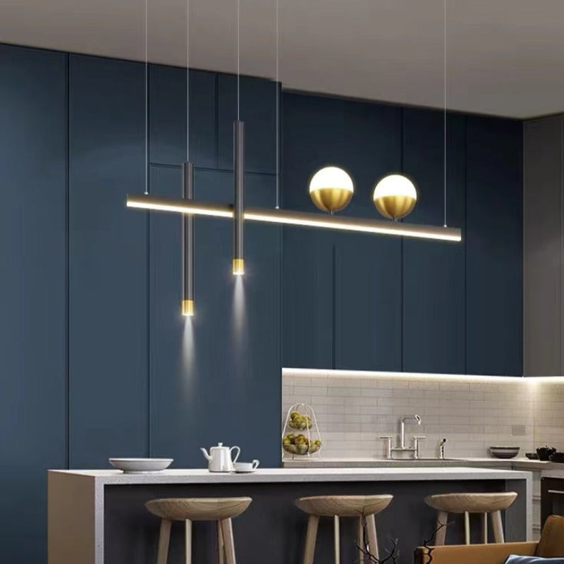 Madina illuminated linear pendant above a counter with stools.