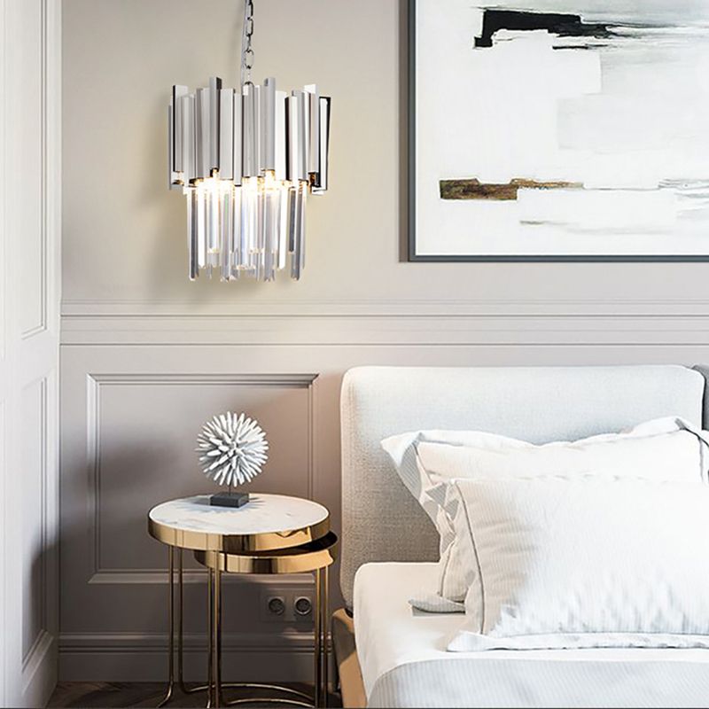 Chrome crystal pendant beside a bed