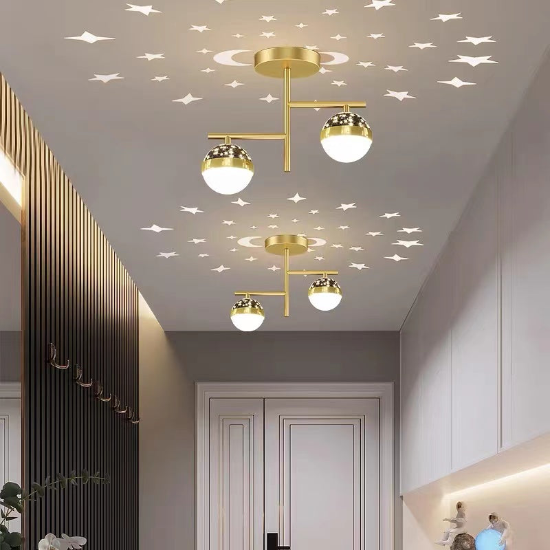 Gold two-globe Madina fixtures repeated in a corridor