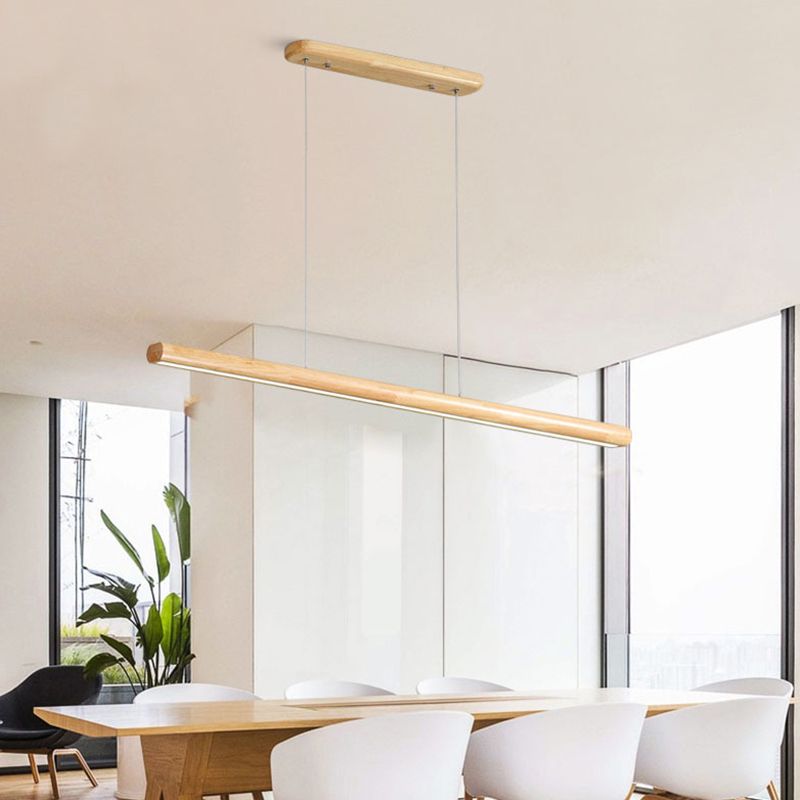 Wooden linear light above a long dining table