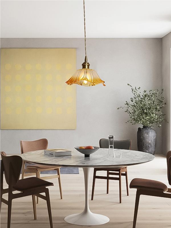 Compact yellow lotus pendant above a dining setting