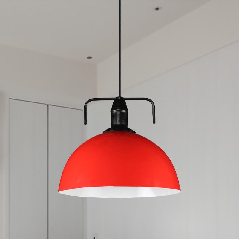 Red dome pendant against white wall