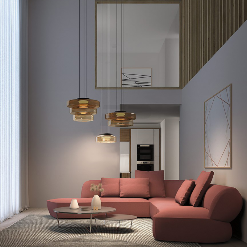 Several amber glass pendants hanging over living-room seating