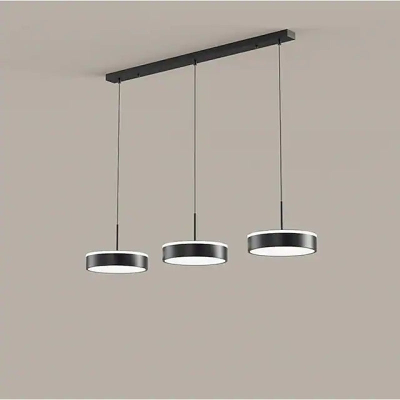 Black Raheel disc heads hanging at slightly different heights below a linear canopy.