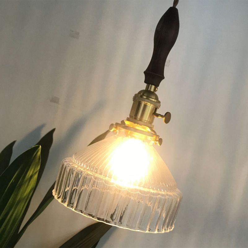 Close angled view of an illuminated Cairns ribbed glass shade