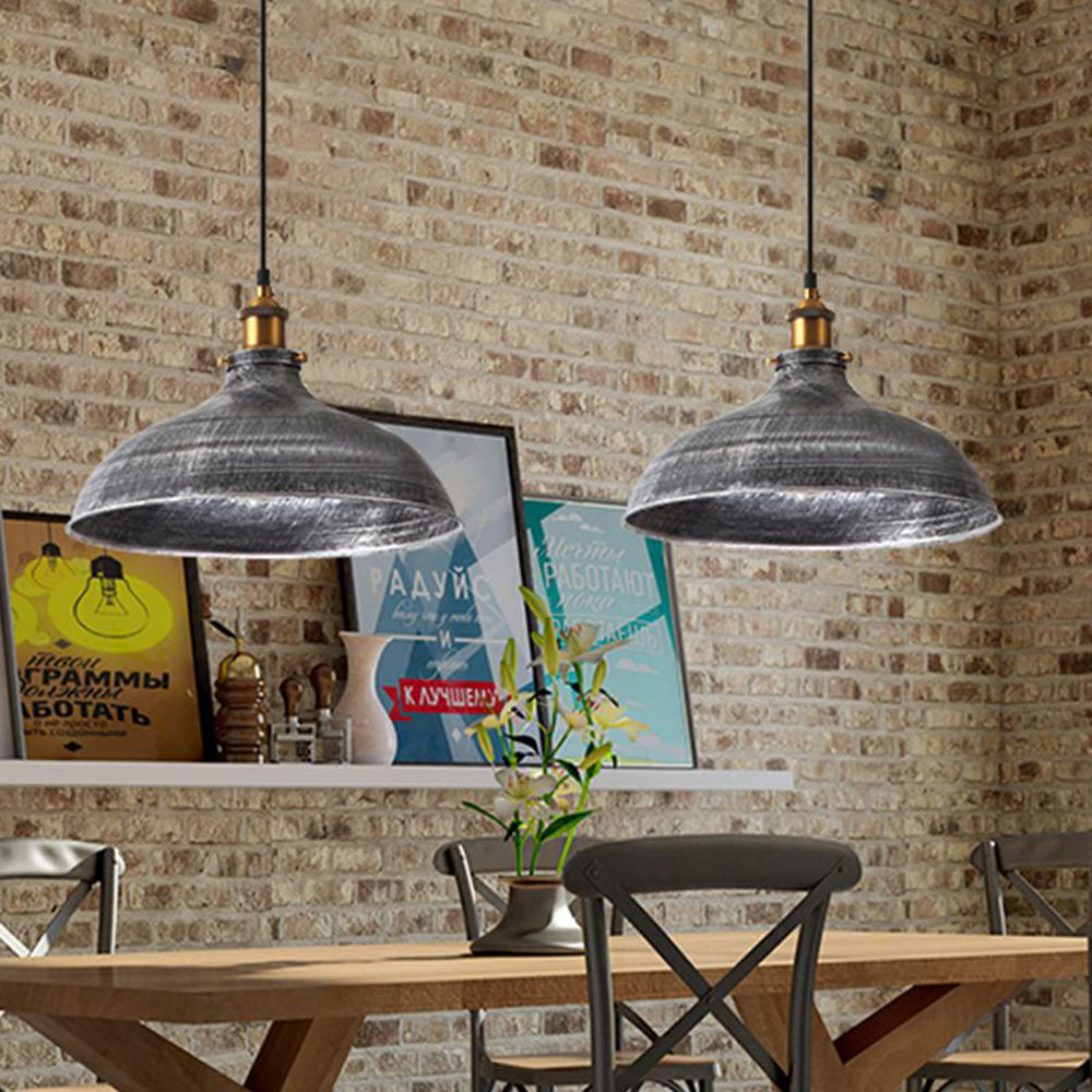 Two Alessio distressed bowl pendants above an indoor dining table.