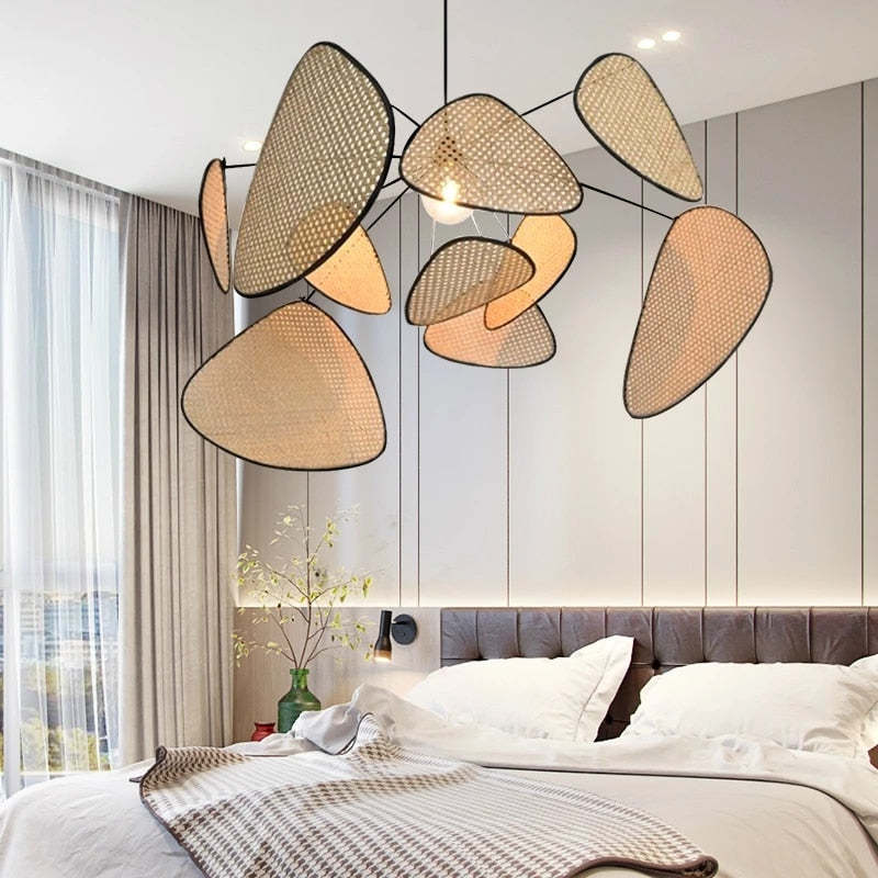 Rattan leaf pendant above a bed in bright bedroom