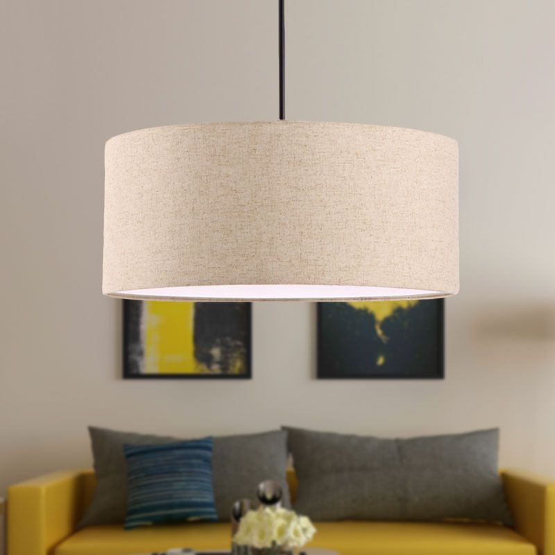 Flaxen Renée fabric drum pendant above a yellow sofa