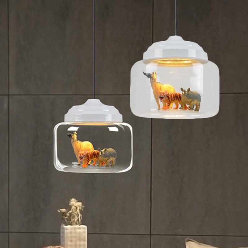 Two Leilani White animal pendants pictured against a gray wall