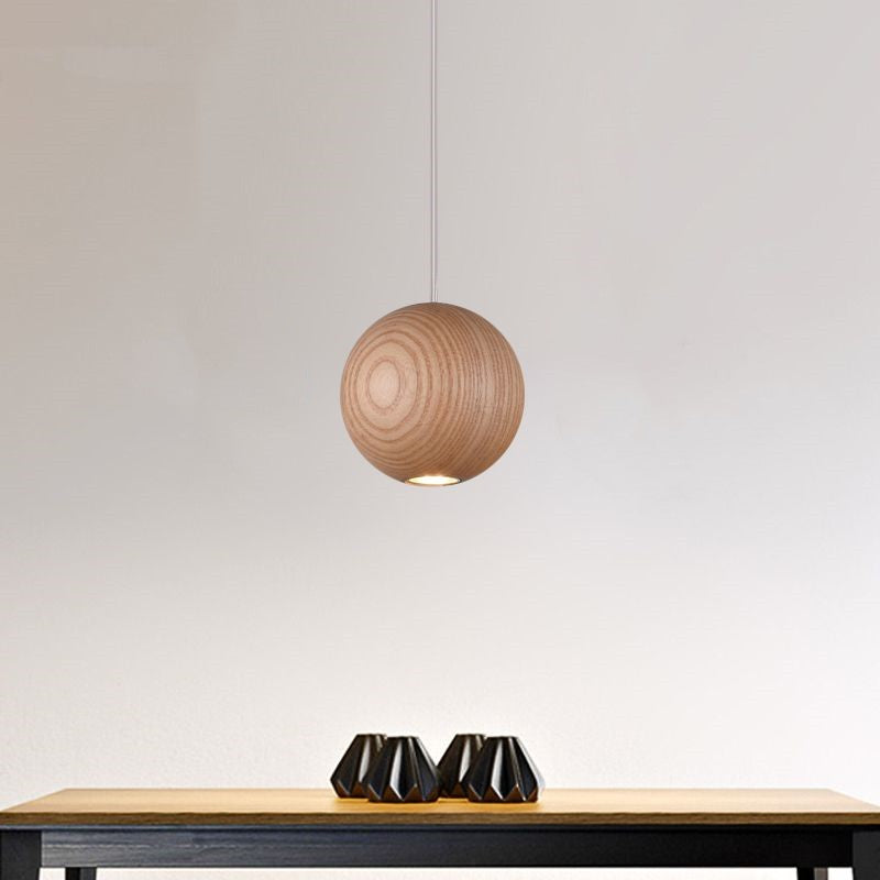 Single wooden globe pendant with visible circular grain