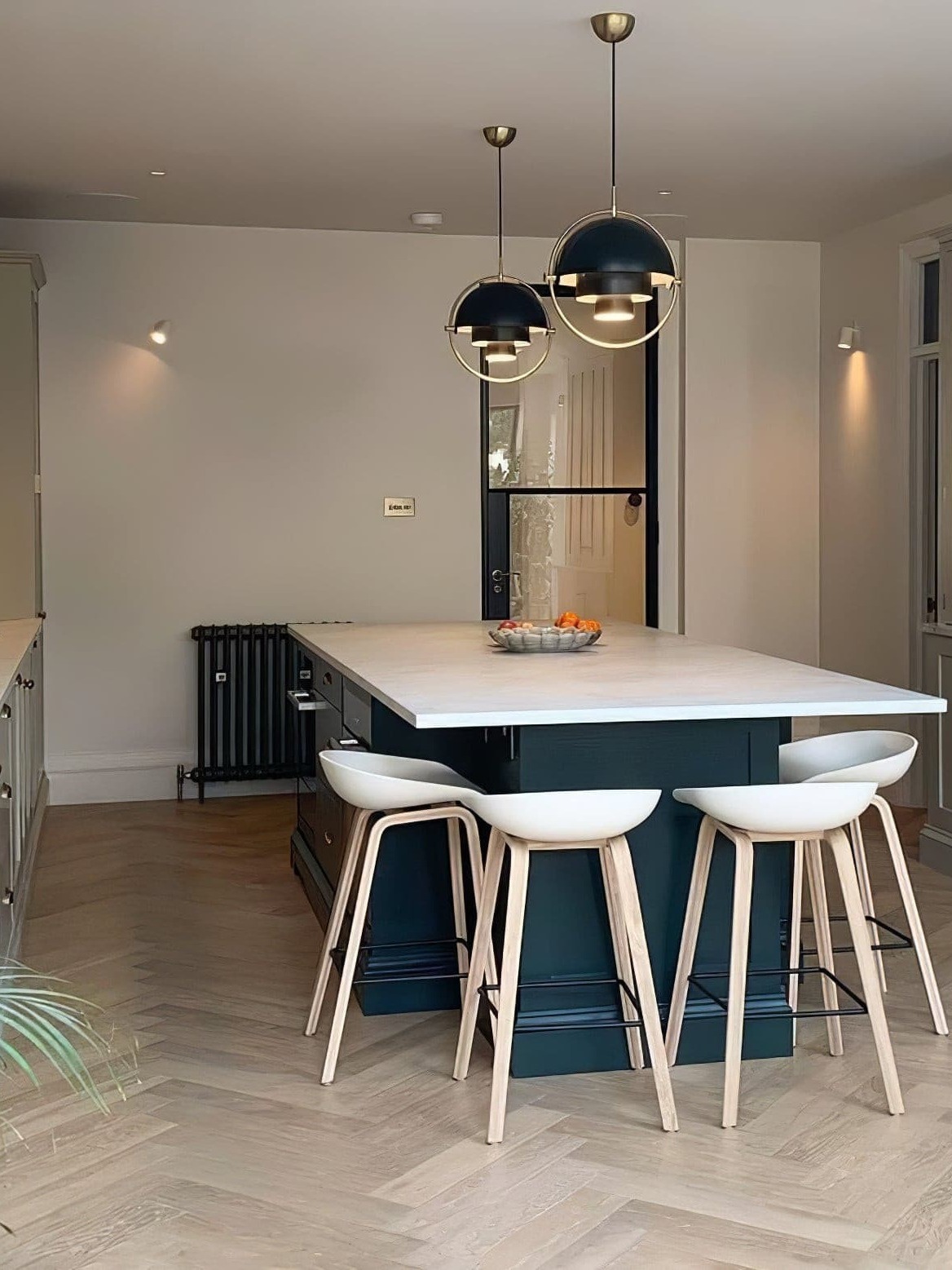 Pair of dark dome pendants above a kitchen island