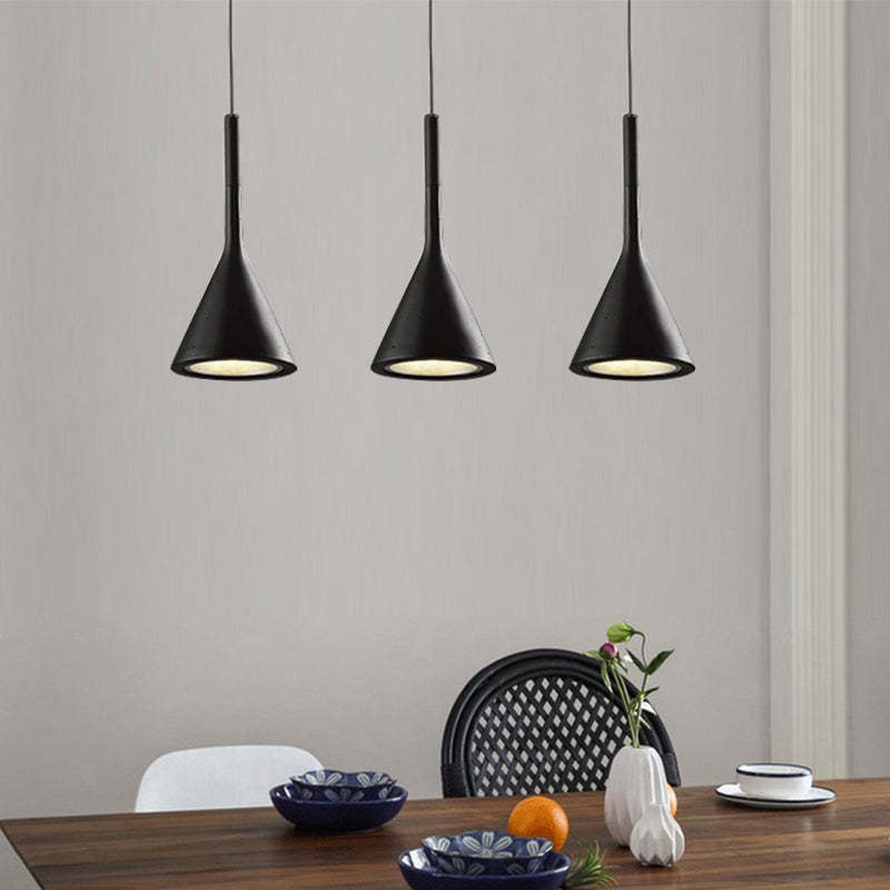 Three black cone pendants above dining table