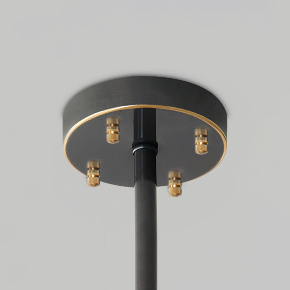 Close-up of the black circular canopy with gold trim, four gold-tone fasteners and central stem