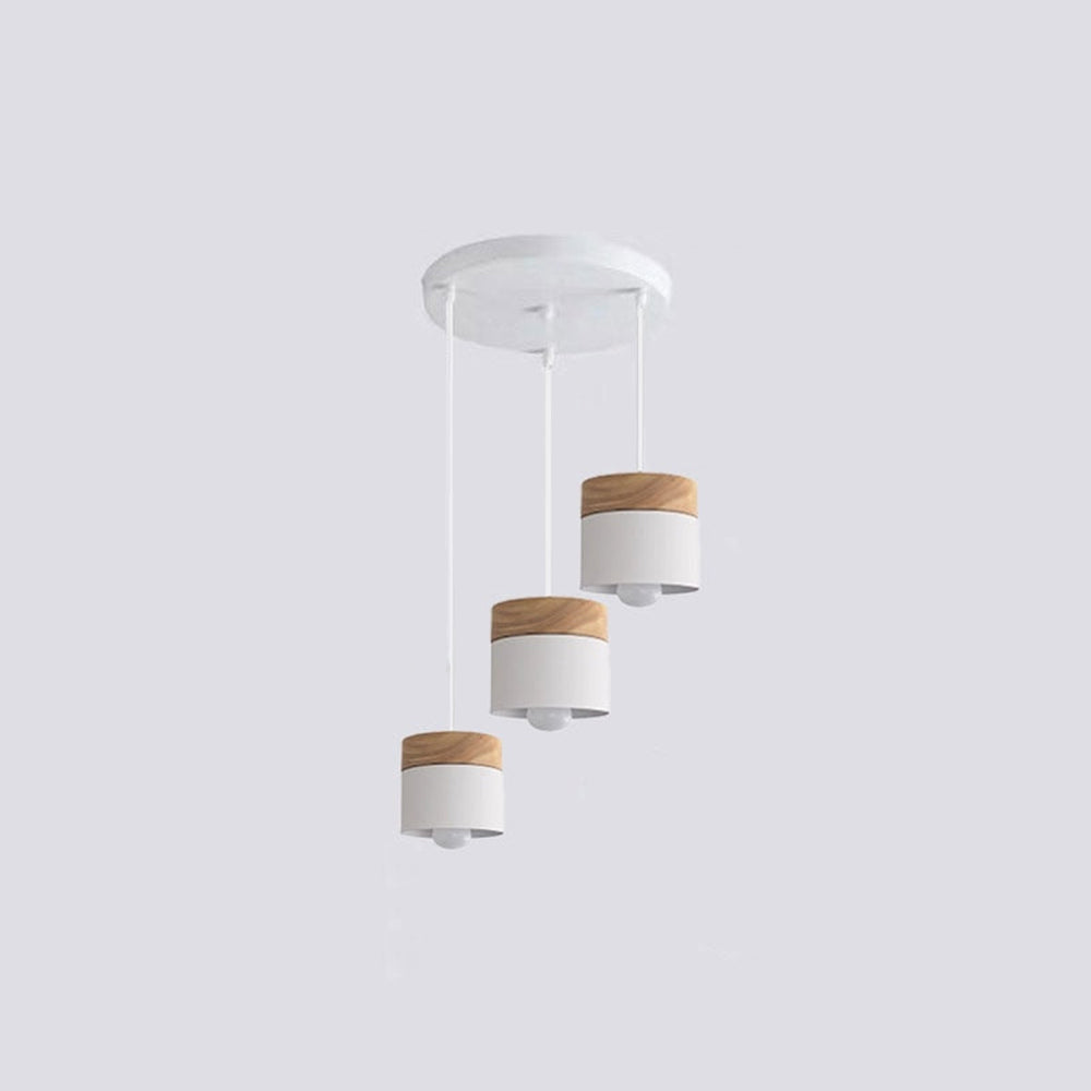Three white wood-accent cylindrical heads at staggered heights below a white round canopy