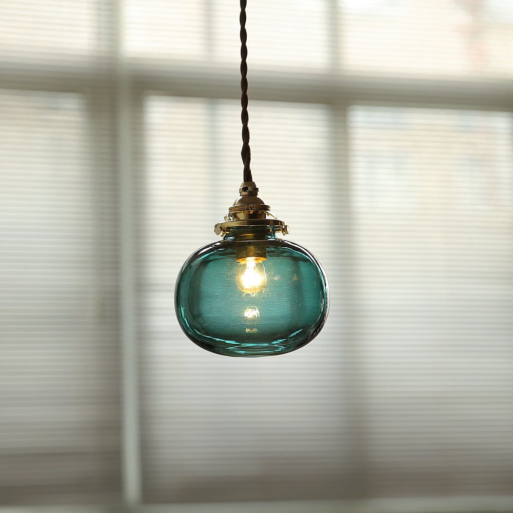 Blackish Green pendant with blue-green glass by window