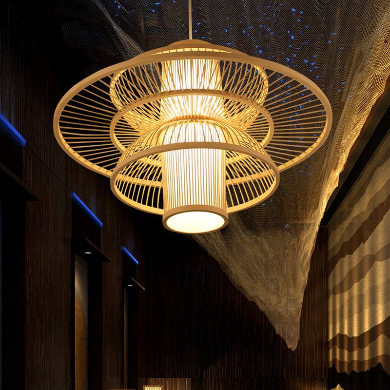 Low angled view of a beige Muto layered woven pendant