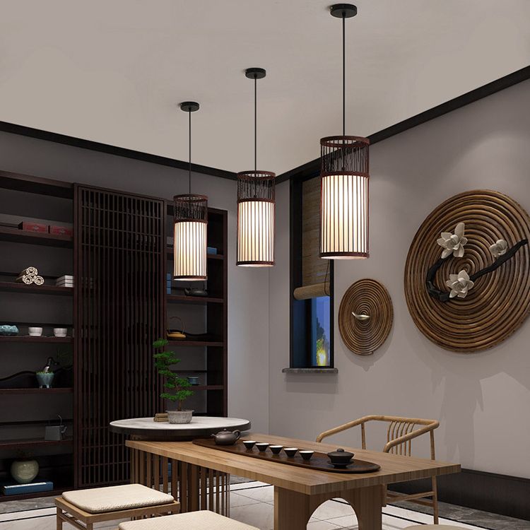 Three Coffee Ozawa pendants hanging at different heights above a wooden table