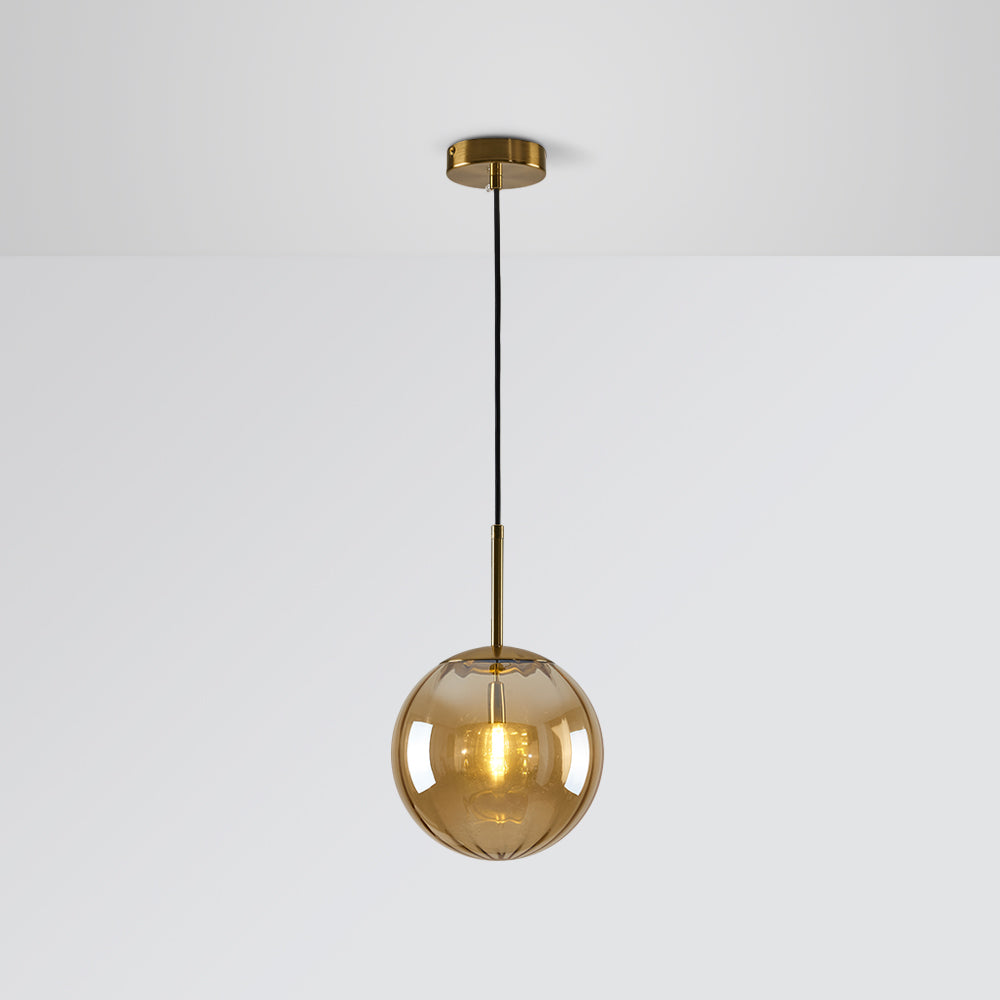 Amber tinted glass globe with glowing bulb, gold-tone stem and round canopy against Gray