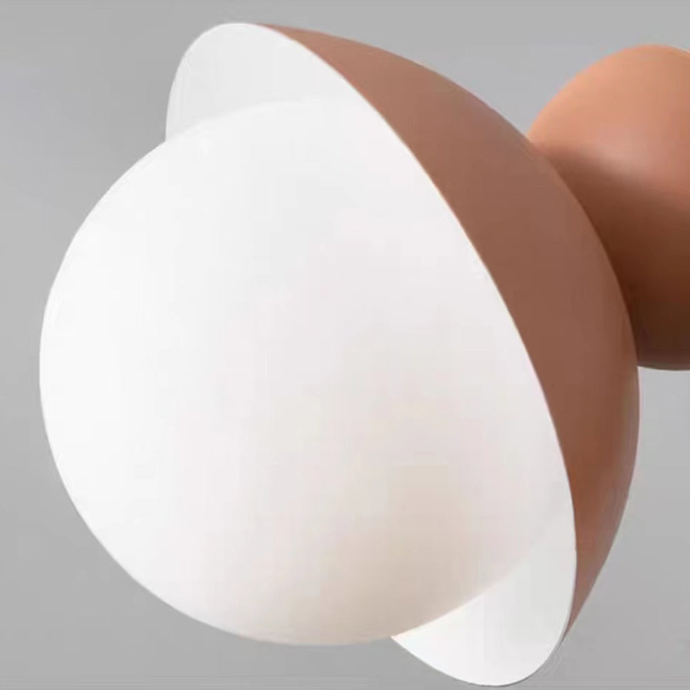 Close view of the Morandi white glass globe inside the pink metal shade