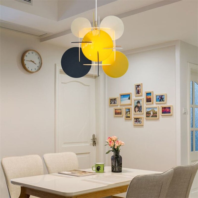 Morandi Yellow/Black/White pendant above a white dining table with flowers, cream chairs and a gallery wall